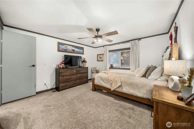 a bedroom with a bed and a ceiling fan