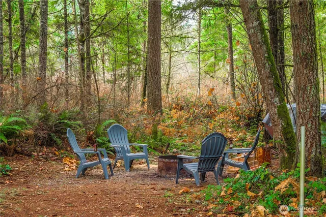 a backyard of a house with table and chairs