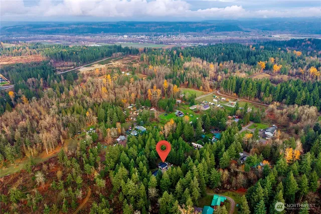 an aerial view of a house with a yard