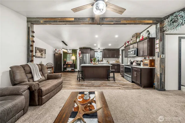 a living room with furniture and kitchen view
