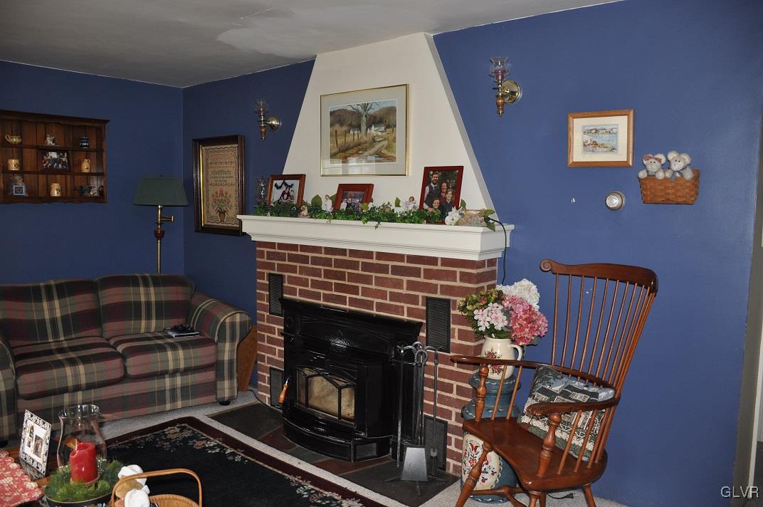 219 Bossardsville Road Sciota, PA 18354 - Photo 11 of 33 Living room fireplace with insert