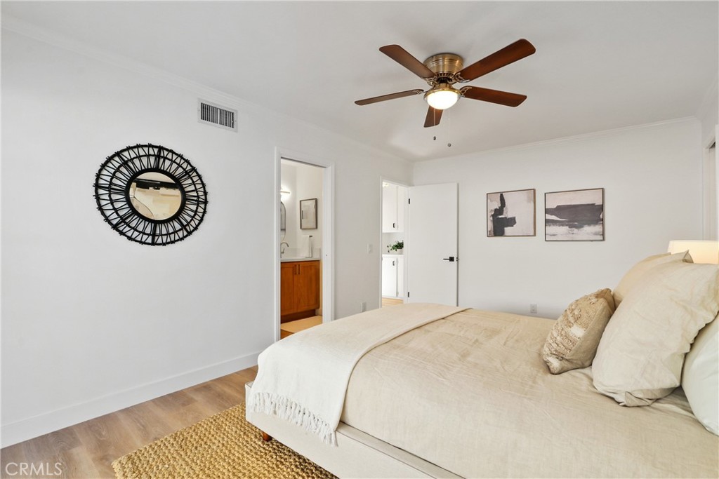 5633 Lakia Drive Cypress, CA 90630 - Photo 13 of 25 a bedroom with a large bed and a chandelier