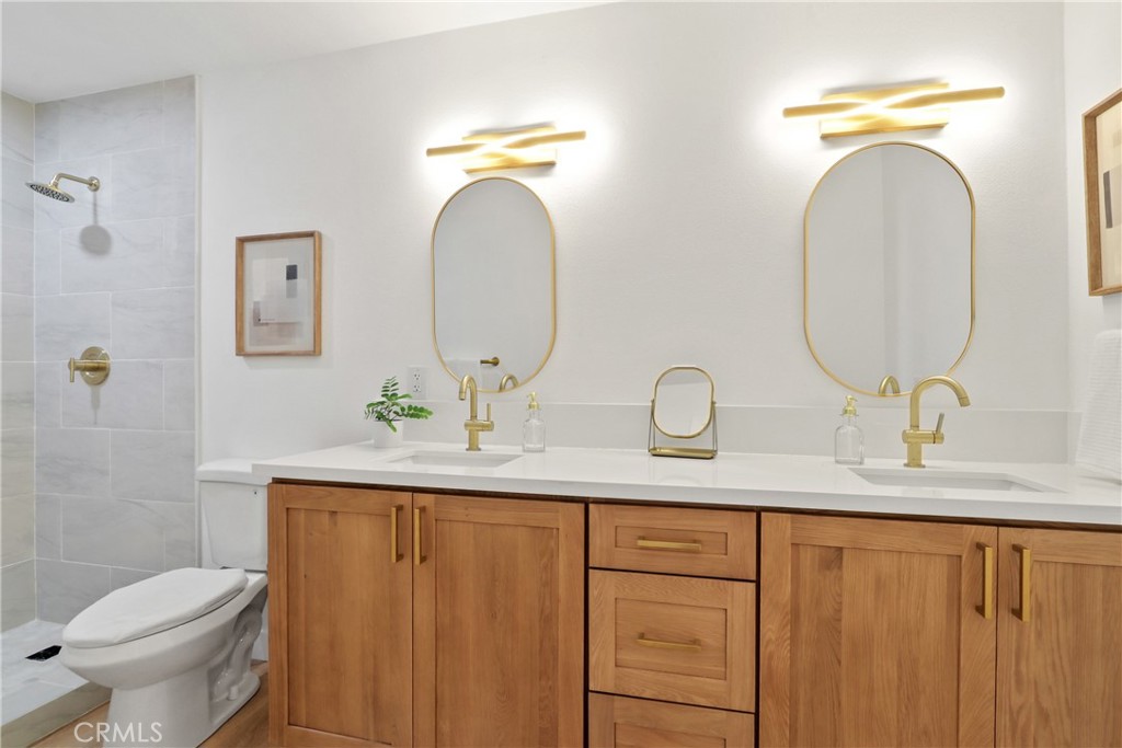 5633 Lakia Drive Cypress, CA 90630 - Photo 14 of 25 a bathroom with 2 sink toilet and a mirror
