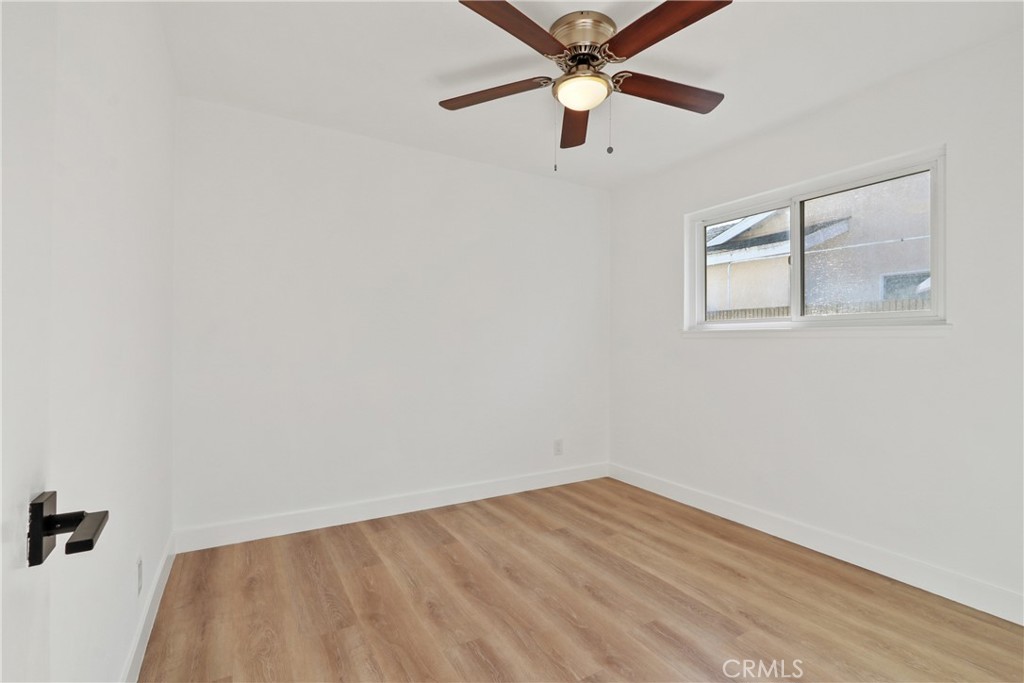 5633 Lakia Drive Cypress, CA 90630 - Photo 18 of 25 an empty room with a window and a fan