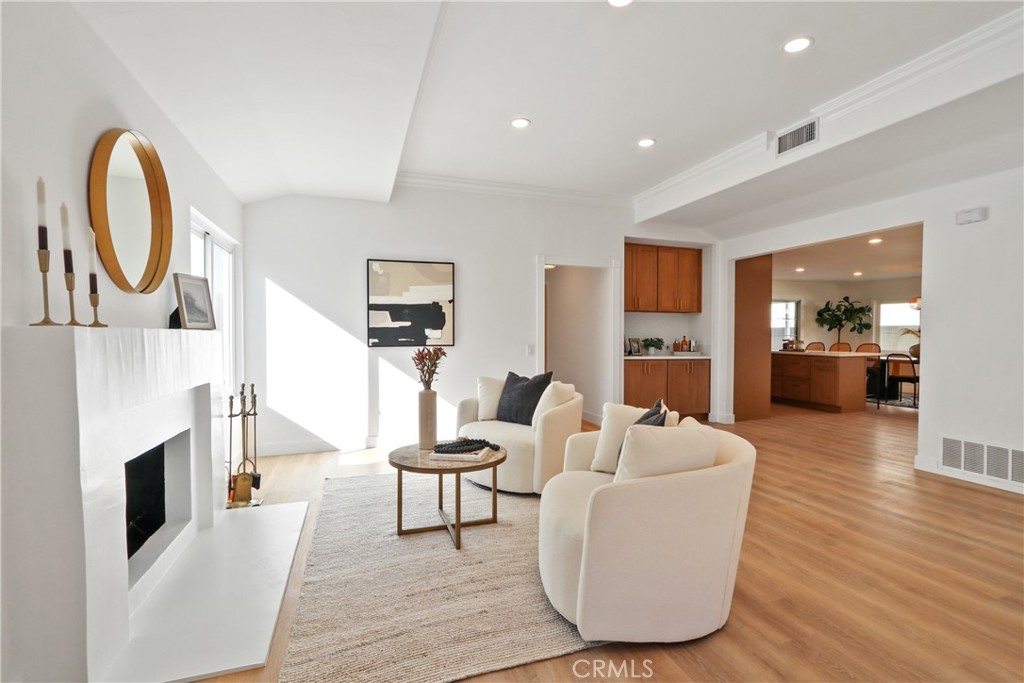 5633 Lakia Drive Cypress, CA 90630 - Photo 5 of 25 a living room with furniture a fireplace and a flat screen tv
