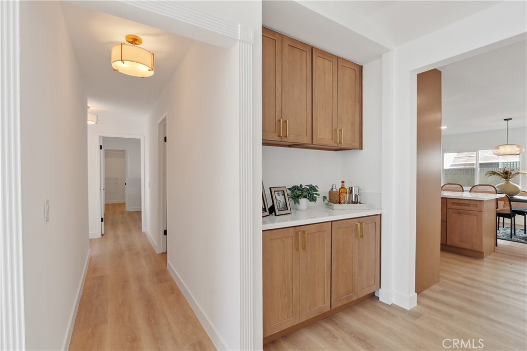 5633 Lakia Drive Cypress, CA 90630 - Photo 8 of 25 a kitchen with cabinets and wooden floor