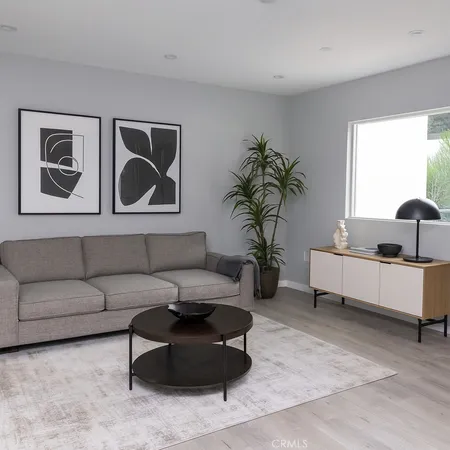 a living room with furniture and a potted plant