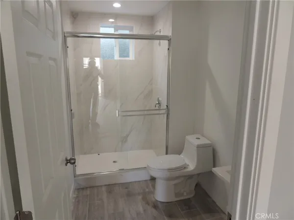 a bathroom with a toilet and a shower