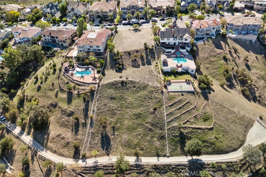 22451 South Summit Ridge Circle Chatsworth, CA 91311 - Photo 13 of 19 an aerial view of a house with a yard and lake view