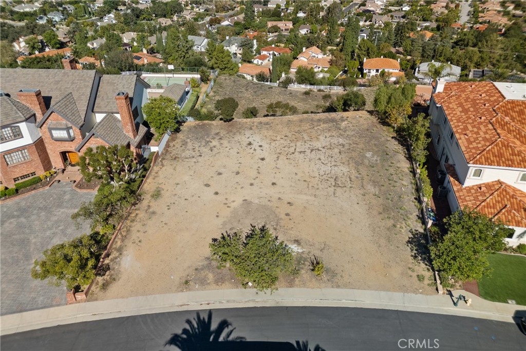 22451 South Summit Ridge Circle Chatsworth, CA 91311 - Photo 10 of 19 an aerial view of a house with a yard and mountain view in back