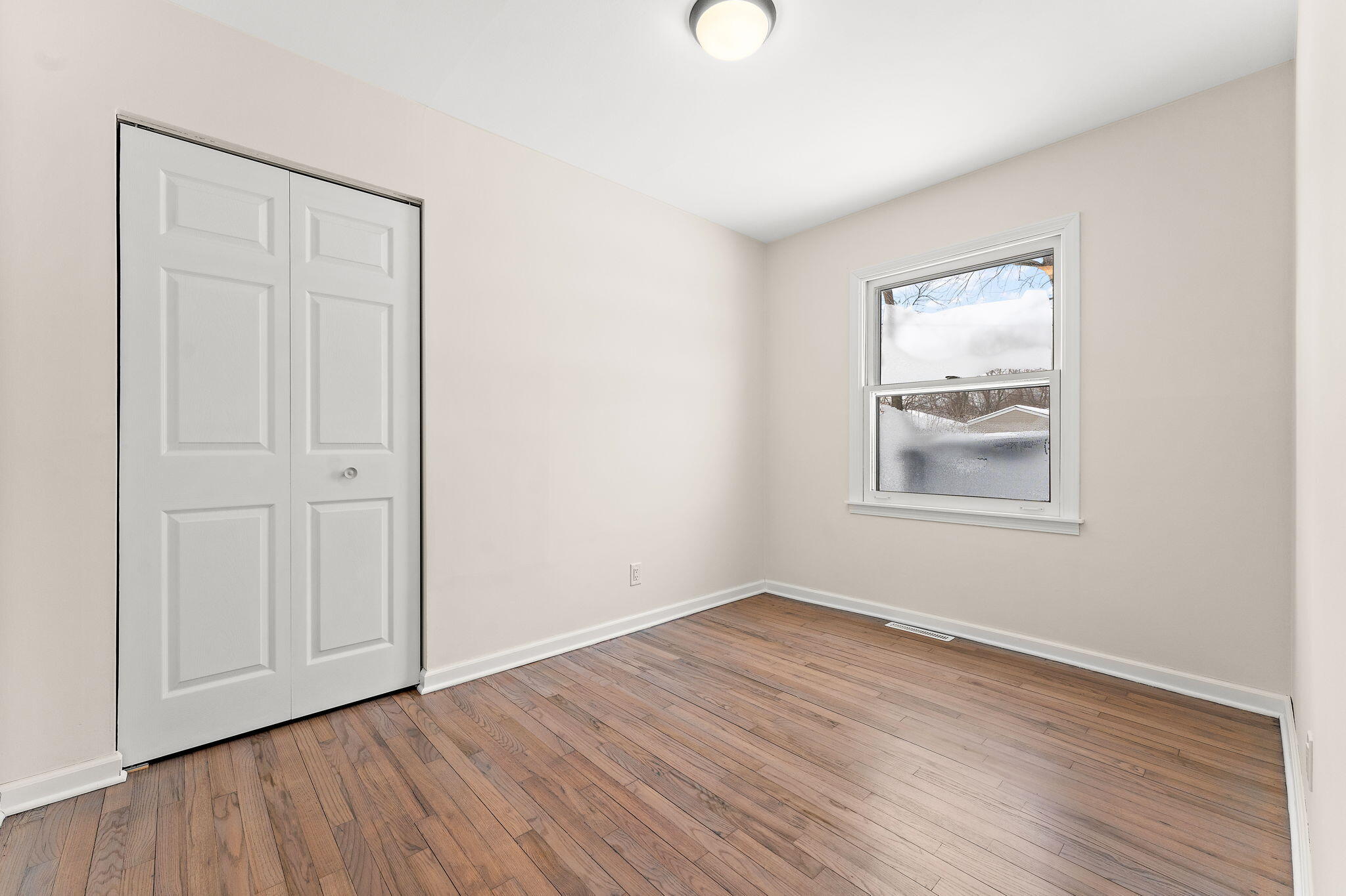 2782 Eleanor Street Portage, IN 46368 - Photo 12 of 20 an empty room with wooden floor and windows
