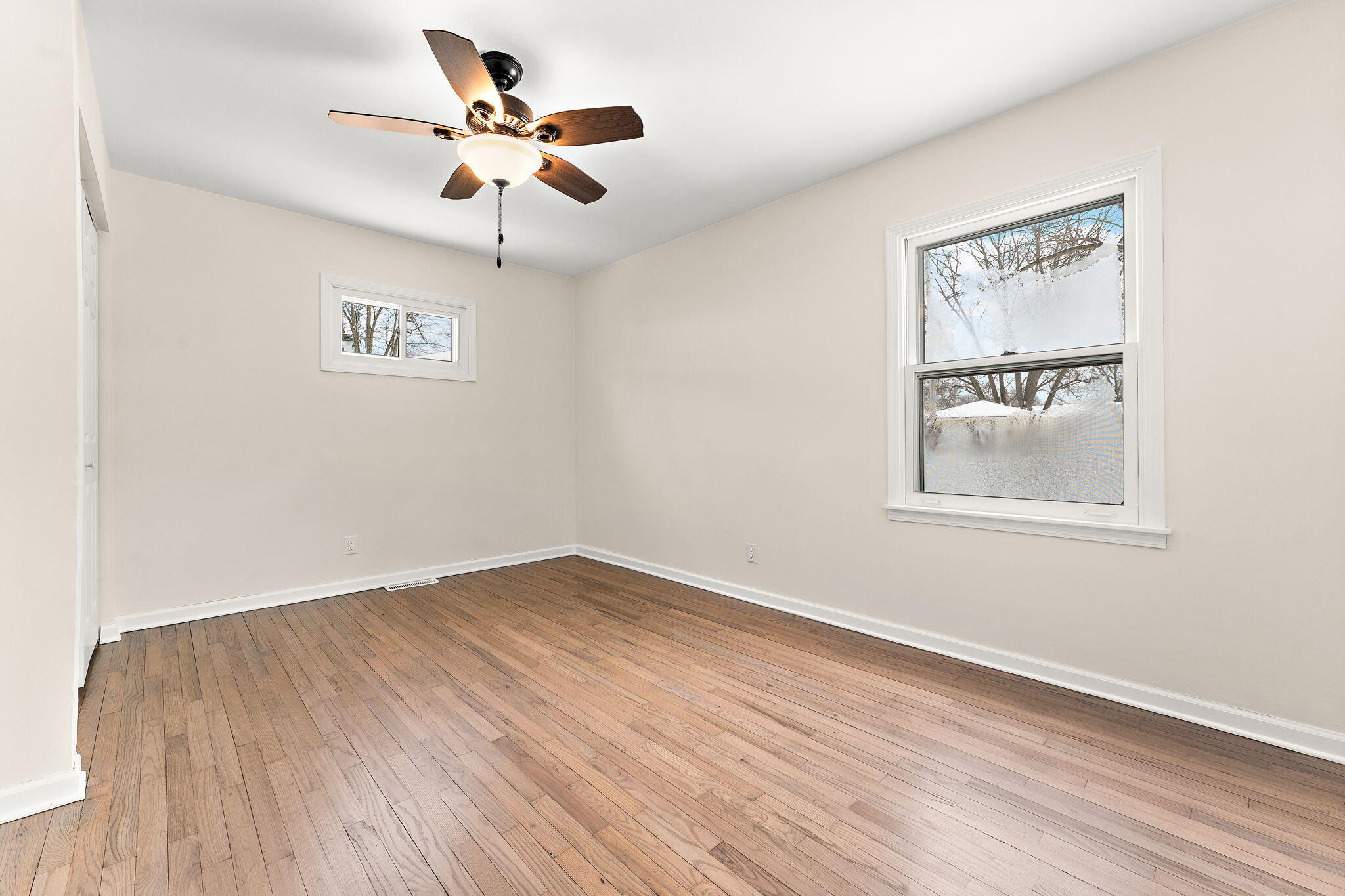 2782 Eleanor Street Portage, IN 46368 - Photo 14 of 20 a view of an empty room with window and wooden floor