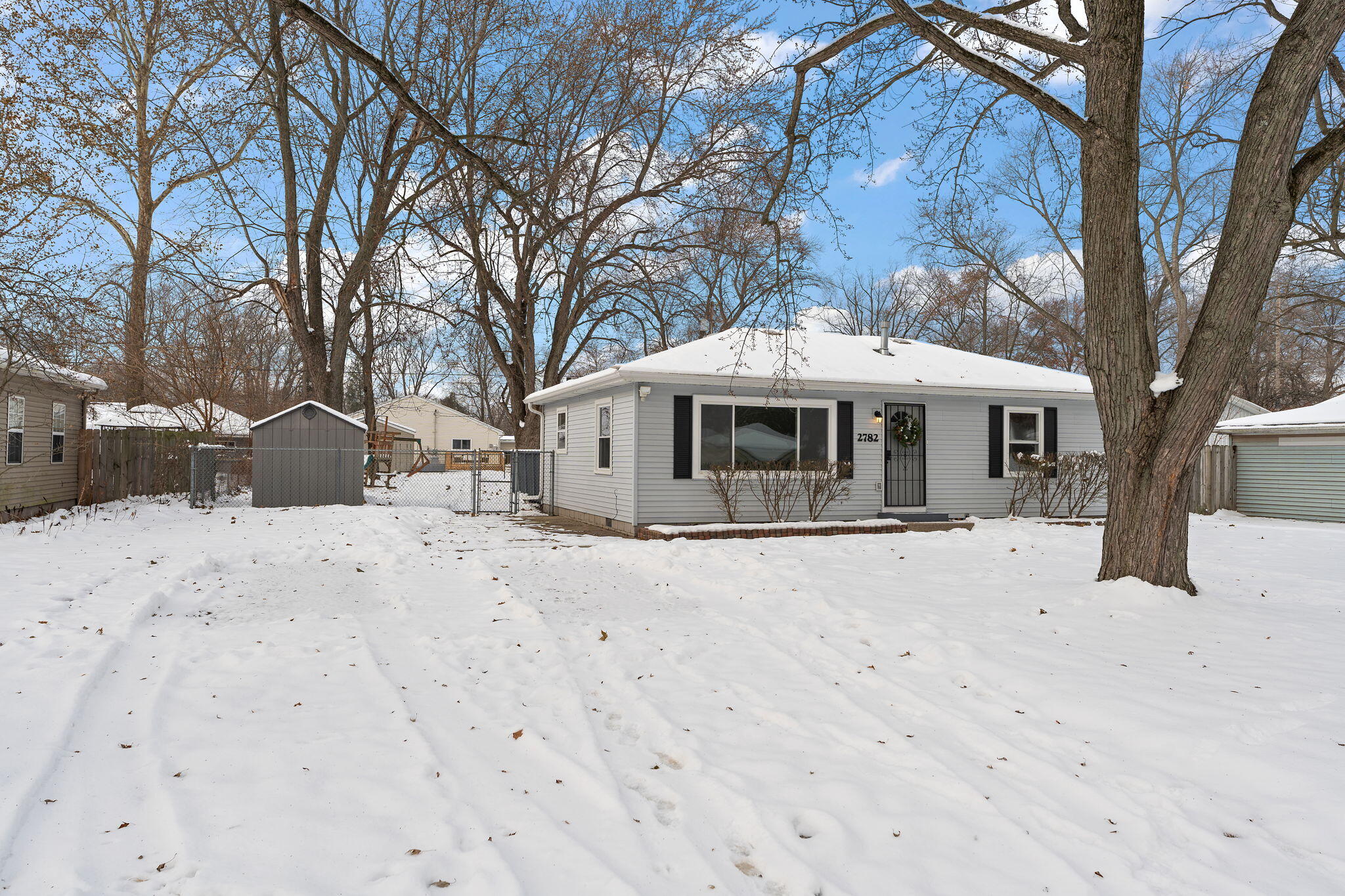 2782 Eleanor Street Portage, IN 46368 - Photo 3 of 20 a view of a house with a yard covered in snow