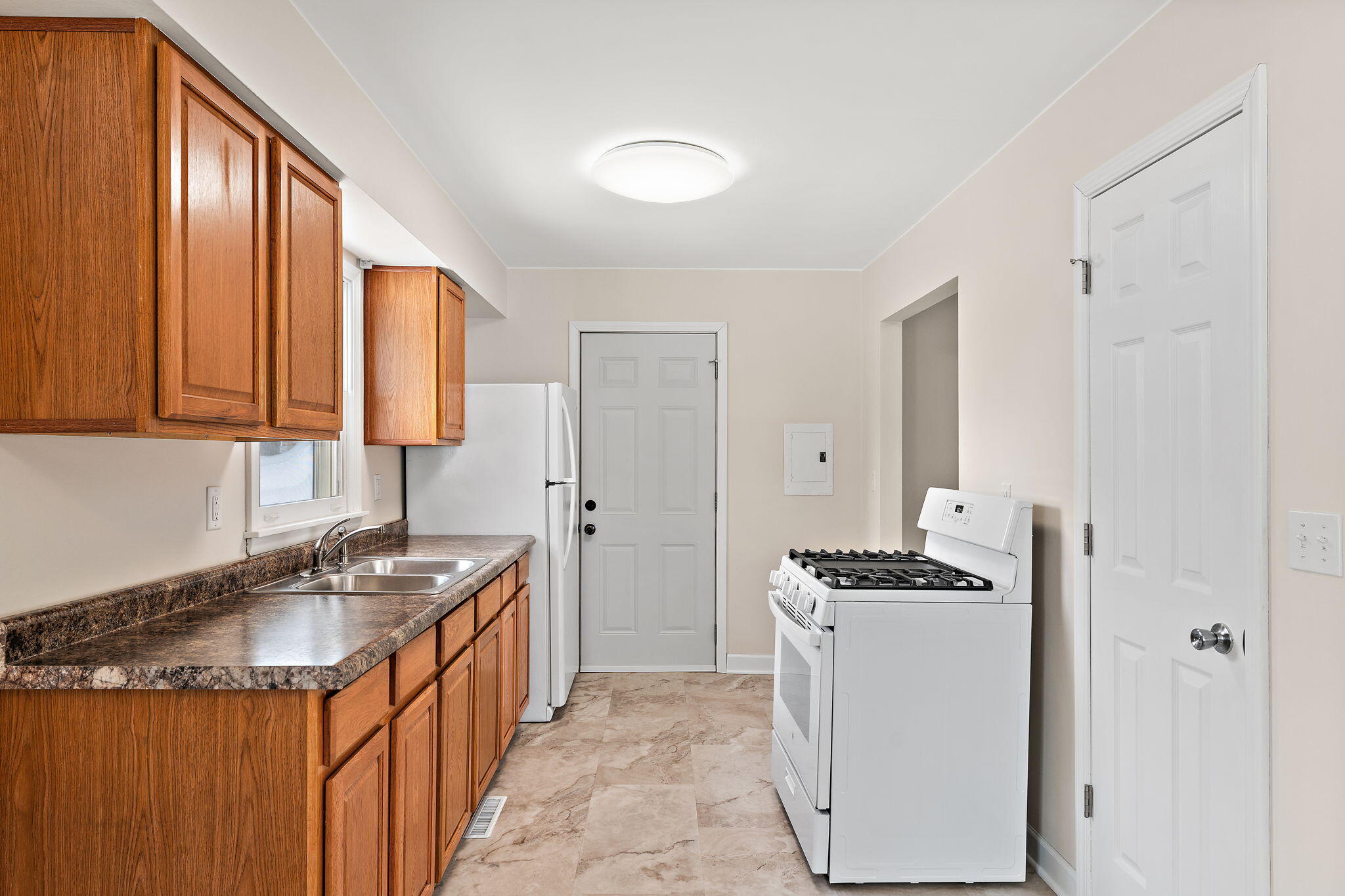 2782 Eleanor Street Portage, IN 46368 - Photo 7 of 20 a kitchen that has a sink and a stove