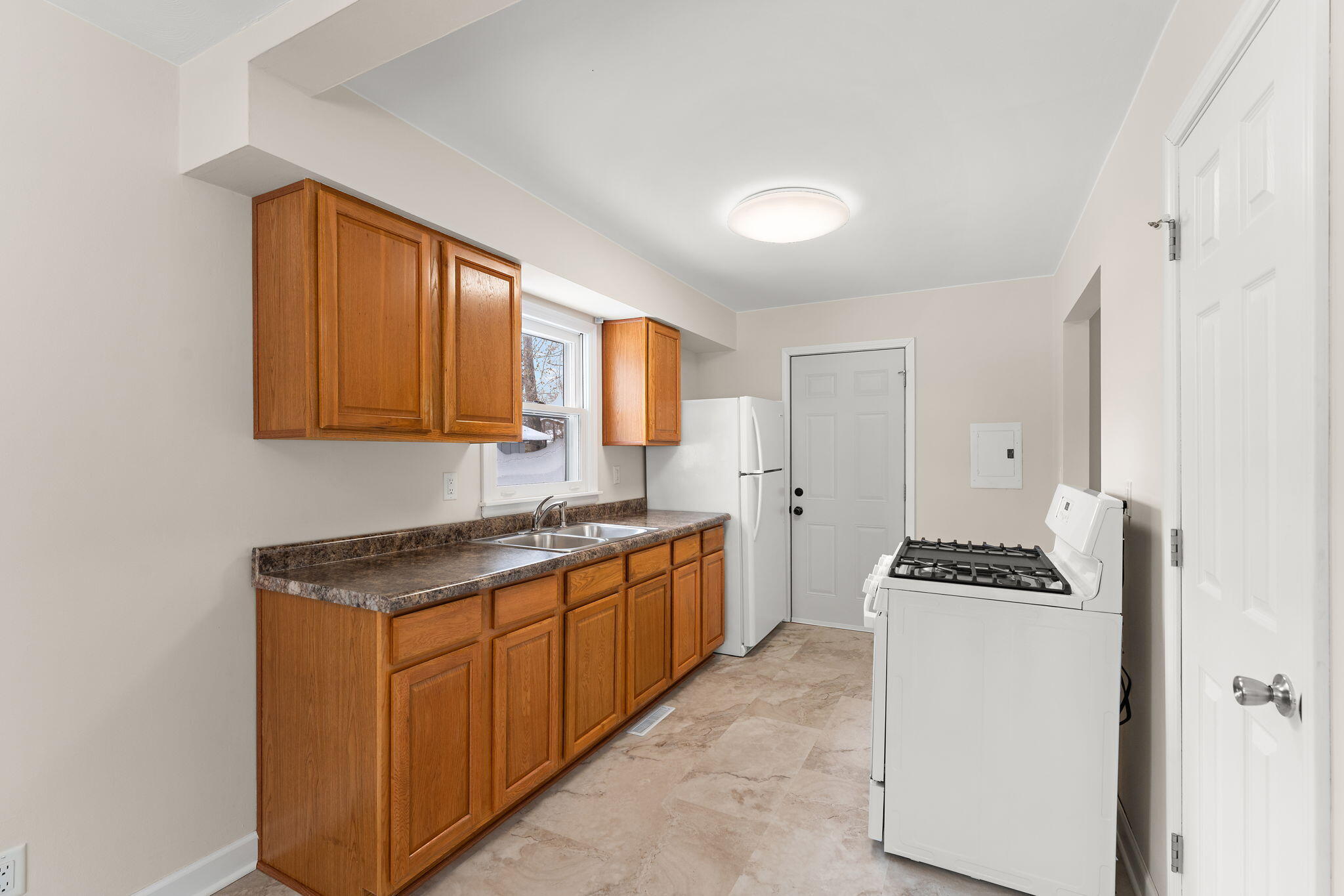 2782 Eleanor Street Portage, IN 46368 - Photo 8 of 20 a kitchen with granite countertop stove top oven sink and cabinets