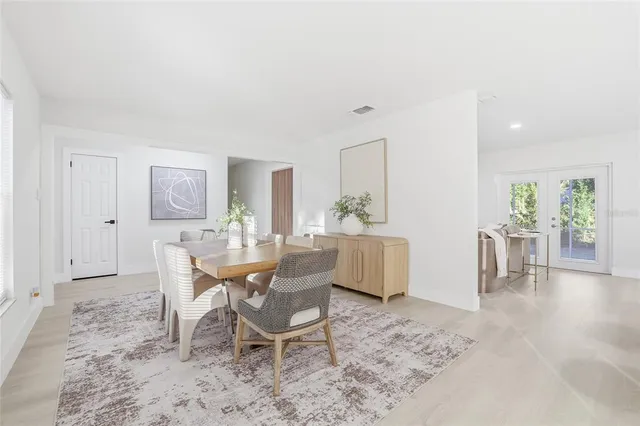 a dining room with furniture and wooden floor