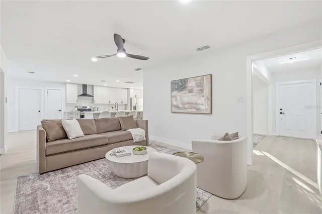 a living room with furniture and a chandelier