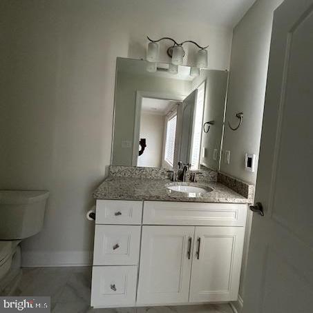 110 Samjan Circle Hightstown, NJ 08520 - Photo 34 of 40 a bathroom with a granite countertop sink a toilet and a mirror