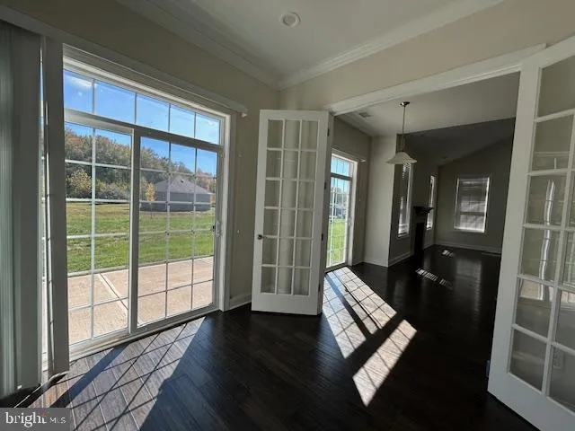 a living room with hardwood floor and windows