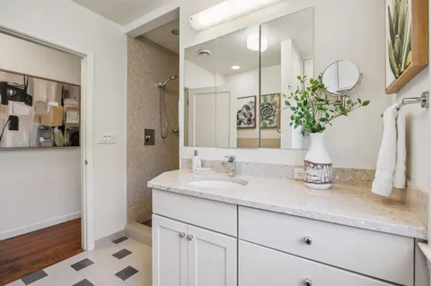 a bathroom with a sink a vanity and a mirror