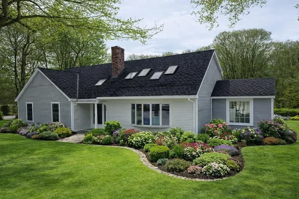 a front view of house with yard and green space