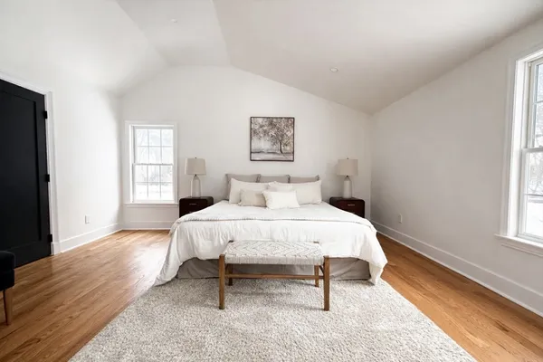 a bedroom with a bed and a window