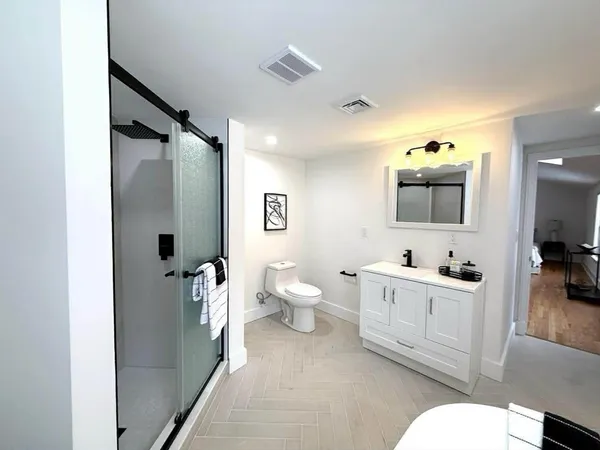 a en suite bathroom with a toilet a sink and mirror