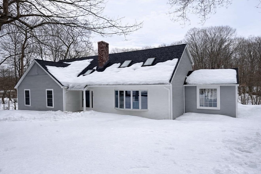 576 Grove Street Framingham, MA 01701 - Photo 2 of 38 a front view of a house with a yard and garage