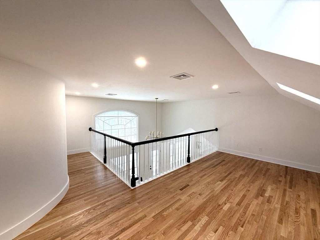 576 Grove Street Framingham, MA 01701 - Photo 22 of 38 a view of an empty room with wooden floor