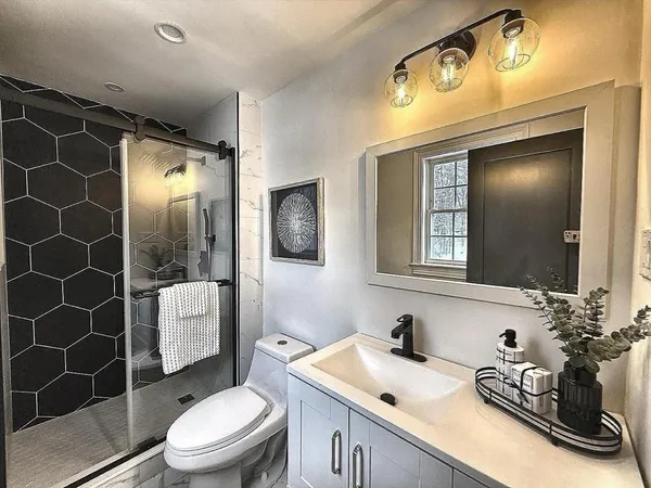 a bathroom with a sink toilet and shower