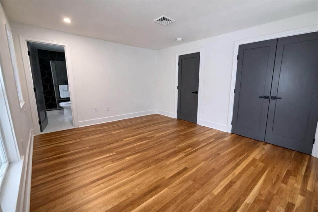 576 Grove Street Framingham, MA 01701 - Photo 27 of 38 a view of empty room with wooden floor