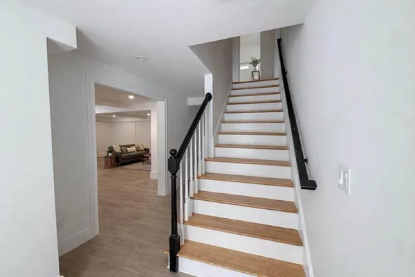 a view of entryway and hall with wooden floor