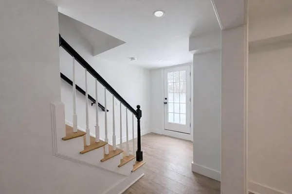 a view of entryway with wooden floor and stairs