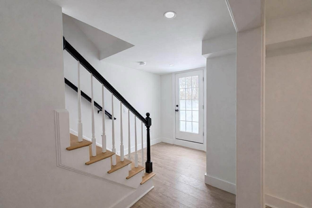 576 Grove Street Framingham, MA 01701 - Photo 31 of 38 a view of entryway with wooden floor and stairs