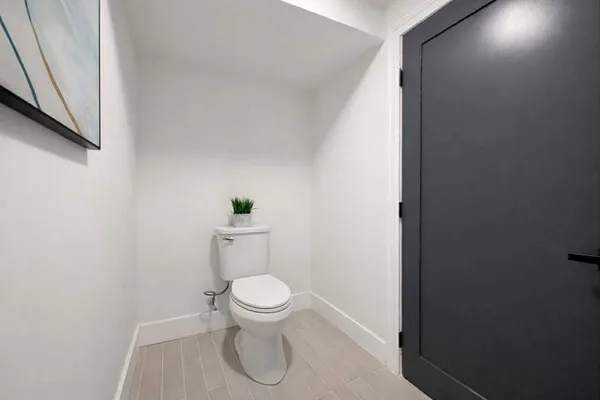 a white toilet sitting next to a shower