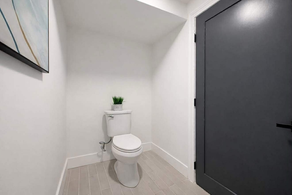 576 Grove Street Framingham, MA 01701 - Photo 35 of 38 a white toilet sitting next to a shower