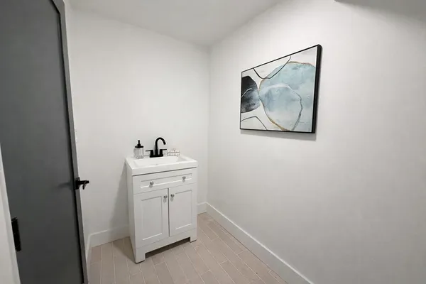 a view of a hallway with closet and cabinet
