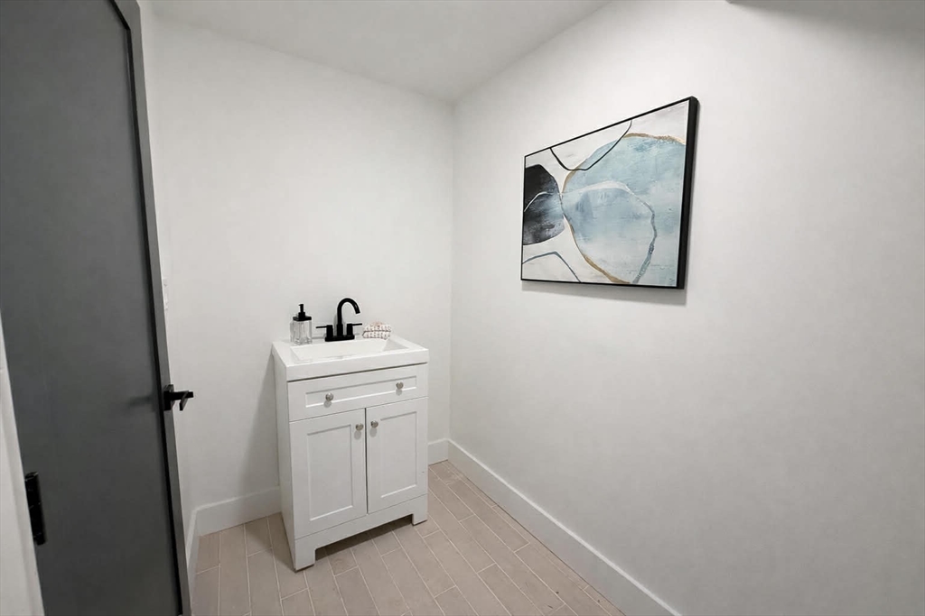 576 Grove Street Framingham, MA 01701 - Photo 36 of 38 a view of a hallway with closet and cabinet
