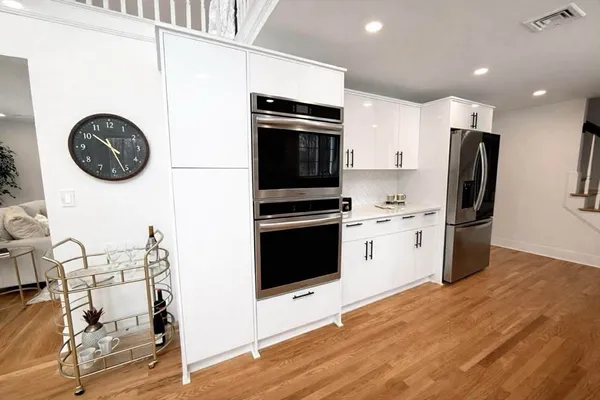 a kitchen with a refrigerator and a stove top oven