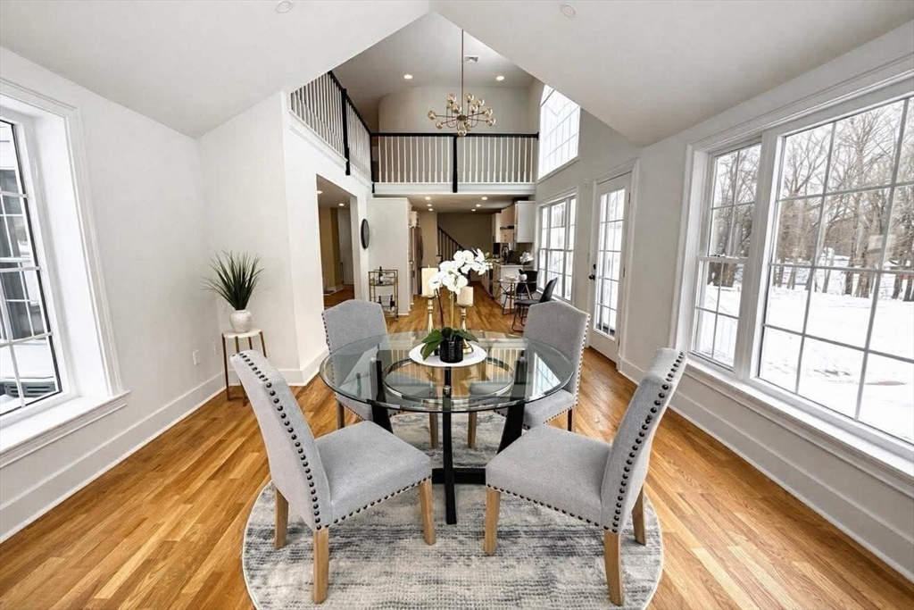 576 Grove Street Framingham, MA 01701 - Photo 8 of 38 a dining room with furniture a chandelier and wooden floor