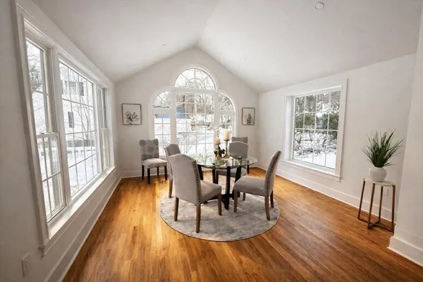 a view of a dining room with furniture window and wooden floor