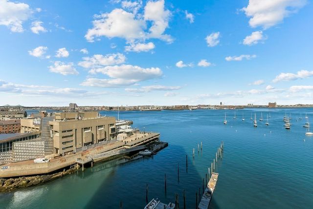 a view of a lake with lawn chairs