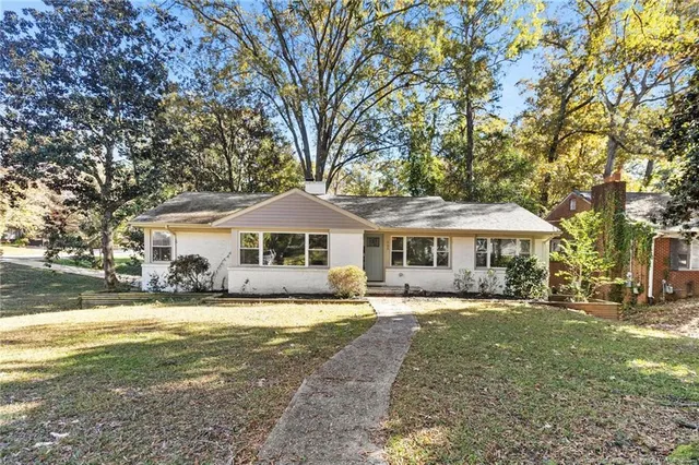 a front view of a house with yard patio and green space