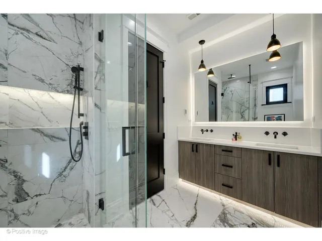 a bathroom with a double vanity sink mirror and shower