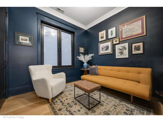 a living room with furniture and a painting