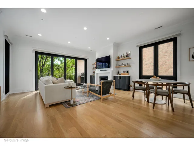 a living room with fireplace furniture and a wooden floor
