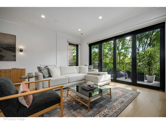 a living room with furniture and large windows