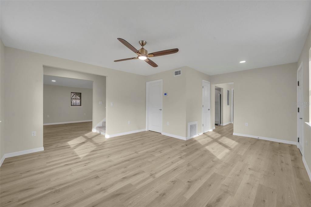 31201 Merry Road Tavares, FL 32778 - Photo 7 of 40 a view of empty room with wooden floor and ceiling fan