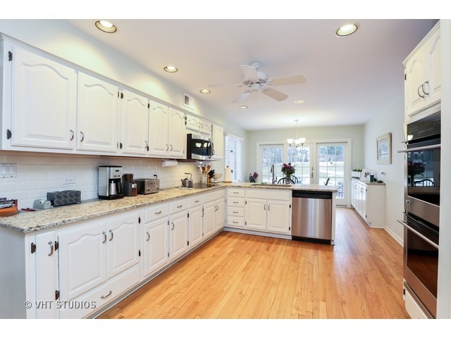 130 Cold Spring Road Barrington, IL 60010 - Photo 4 of 23 a large kitchen with stainless steel appliances granite countertop a lot of counter space and wooden floors