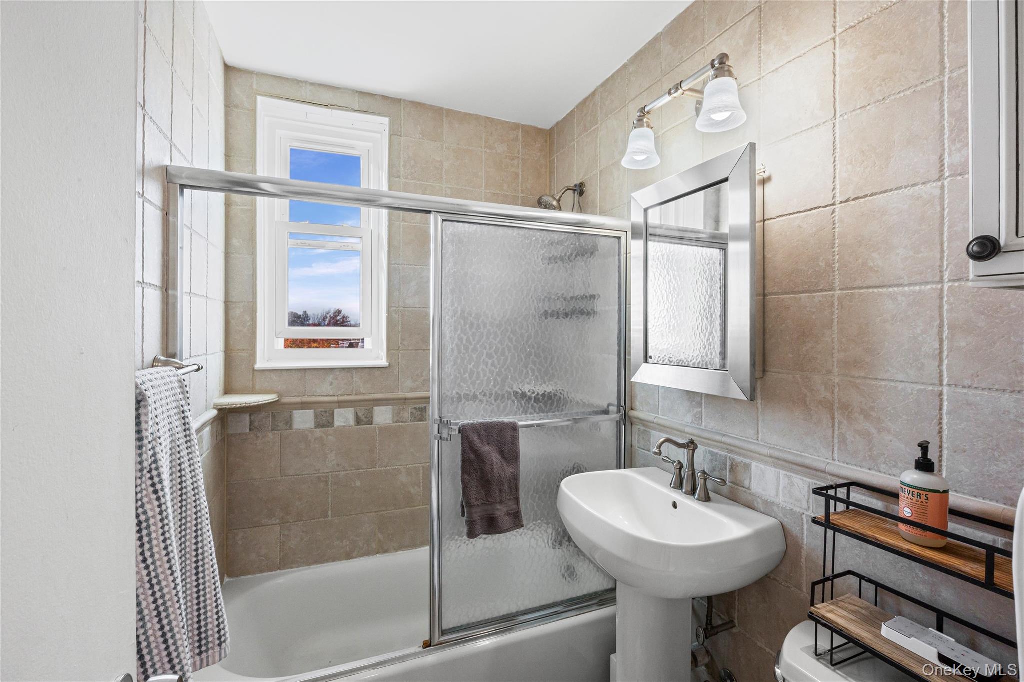 504 Merrick Road, Unit 4E Lynbrook, NY 11563 - Photo 13 of 19 a bathroom with a sink toilet and shower